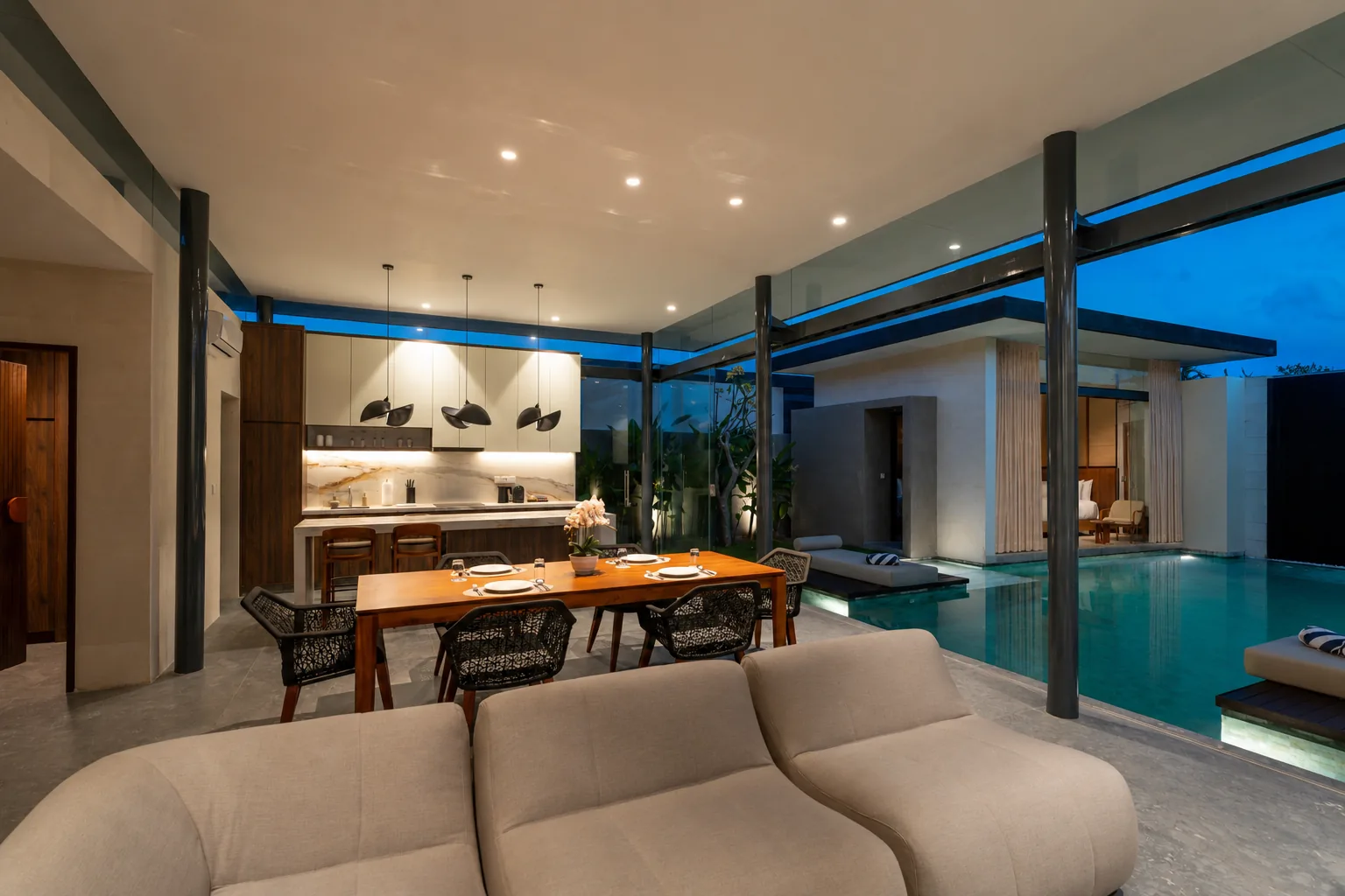 Living, dining and pool areas at dusk inside the two-bedroom villa