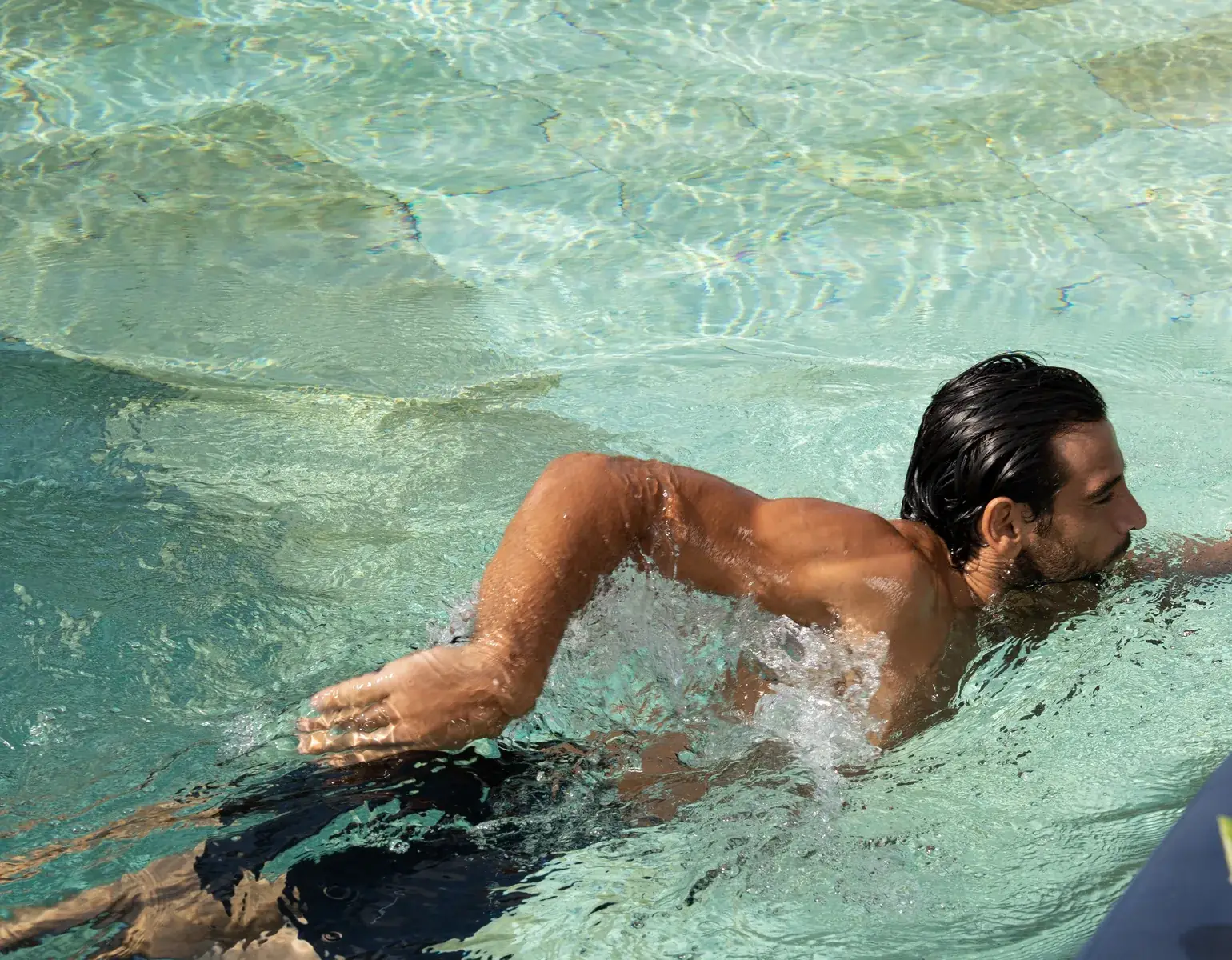 A guest swimming in the pool at Pronoia Bali