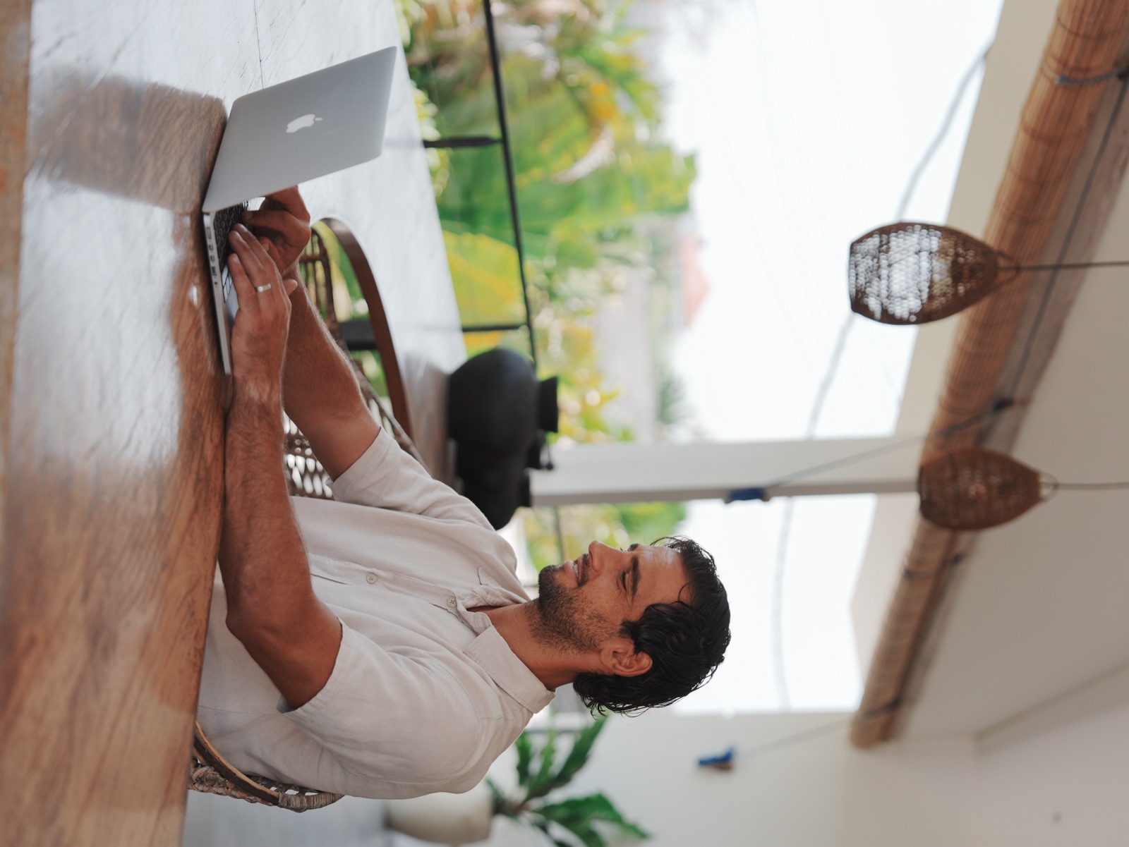 A guest working from a quiet terrace table at Pronoia Bali